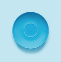 Blue plates on blue table. Monochrome minimalistic image in hipster style.
