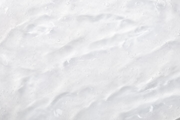 Cosmetic gel, serum transparent sample. Liquid cream with bubble texture. Gel texture of a cosmetic product. Clear liquid lotion for skin care.