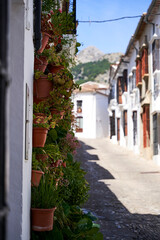 Typical spanish street with houses in spain, small town, white and brown walls