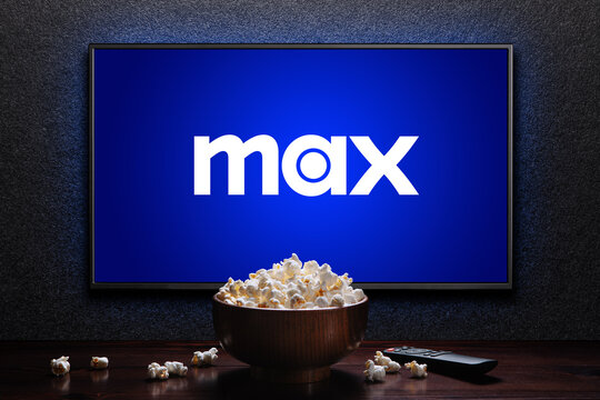 Max or HBO Max logo on TV with popcorn bowl and reomote control on the table. HBO Max is an American subscription video on-demand streaming service. Astana, Kazakhstan - July 21, 2023.