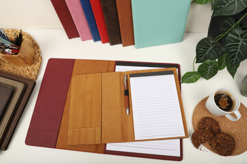 desktop top view, agenda view, blank writing space, bamboo and red colored agendas, coffee and cookies top view