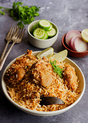 South Indian Style Chicken Biryani with Onion, Cucumber, Lemon and Cilantro Vertical Photo
