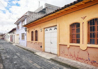 Street of Latacunga town paved with cobblestone, Ecuador.