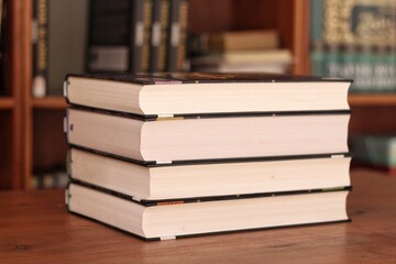 Book stack in the library room and blurred bookshelf for business and education background, back to school concept