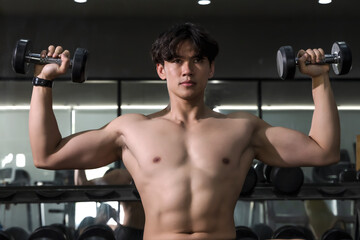 Fototapeta na wymiar Shirtless Sportsman doing exercise in gym, Fitness man iwork out in sport club