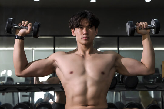 Shirtless Sportsman doing exercise in gym, Fitness man iwork out in sport club