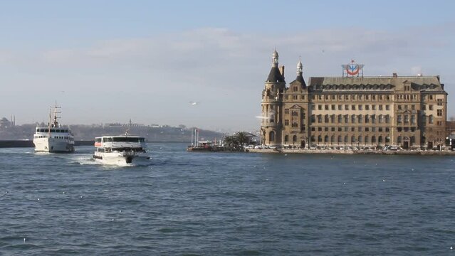 Historical Haydarpasha train station and seagulls flying in the sea in Istanbul in 1916