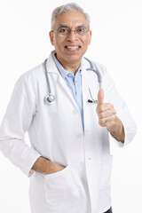 Senior male doctor giving thumbs up
