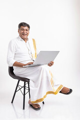 South Indian Senior man using a laptop
