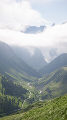 Mountain landscape with the clouds on the hills at sunrise
