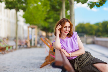 Beautiful successful middle aged woman posing on the street photo shoot