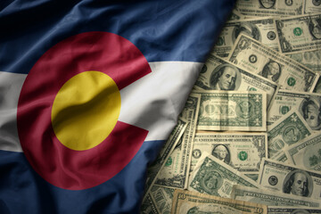 colorful waving national flag of colorado state on a american dollar money background. finance concept
