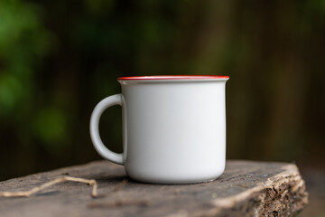 Expertly arranged mockup showcases a mug, beautifully presented with a simple outdoor arrangement in a natural setting, adding charm to your designs