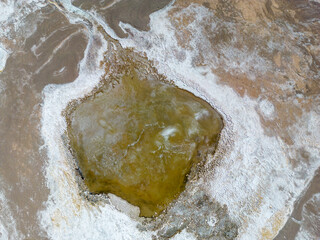 Close up aerial view of the green and partly frozen Laguna del Negro Francisco in the Atacama desert in Chile - Traveling and exploring South America