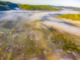 Photos of the hills and the village were taken from a drone in the early morning.  Kuldur is an urban—type settlement in the Irradiation district of the Jewish Autonomous Region of Russia. Resort. 