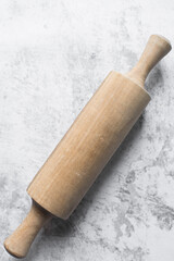 Top view of wood rolling pin on a marble surface