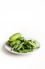 Fresh cucumbers with green beans isolated on white 