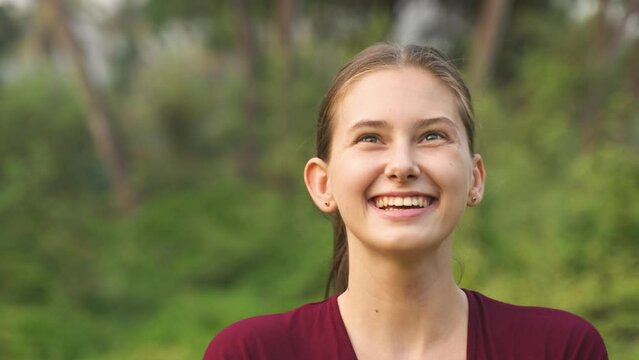 young woman is juggling balls, with a close-up of her smiling face