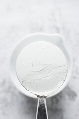 All purpose flour in a measuring cup, one cup of flour