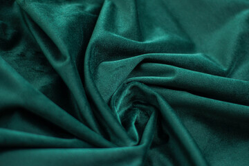 emerald velvet with folds background image, green shiny fabric silk for background web design...