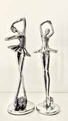 two small figurines of ballerinas