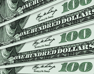 One hundred US dollar bills spread out like a fan