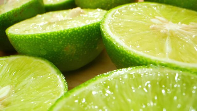 Half green lemons probed, revealing nature's tangy essence through a lens of curiosity. A zesty journey awaits, unearthing citrusy secrets. Food concept
