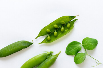 Close-up of freshly picked green peas isolated on a white background. peas inside pod. top view