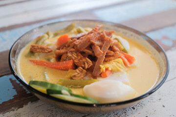 Lontong-Traditional Malaysian and Indonesian food on wooden table