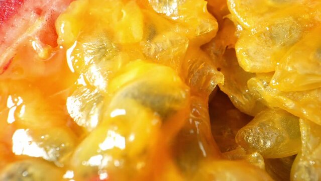 Discover the mesmerizing world of half a passion fruit through a captivating macro video. This probe lens exploration delves into its luscious pulp, revealing intricate textures and seeds
