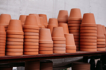 Stacked terracotta flower pots on the shelves at the garden center