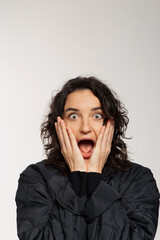 Beautiful girl with curly hair and bright emotions on white background