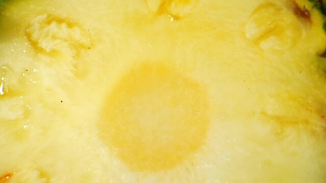 Explore the tantalizing world of pineapple slices up close with a mesmerizing macro video. Shot with a probe lens, witness intricate textures, vibrant colors, and juicy details. Pineapple background
