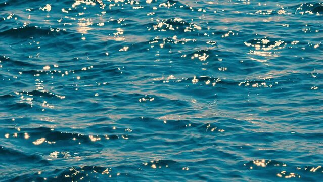Fresh landscape of twinkling waves by sunlight at blue sea or ocean near a beach in summer, Nobody, Travel or vacation background, Slow motion