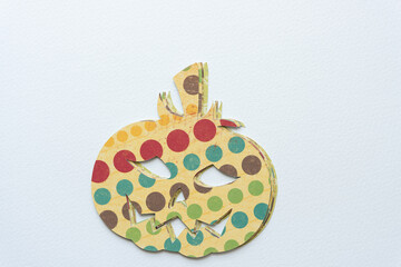 pile of sophisticated scrapbook paper halloween jack-o-lantern cutouts on blank paper