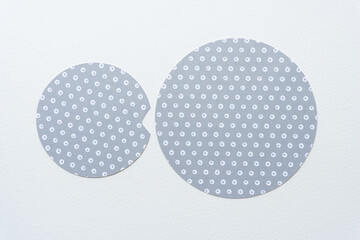 cut paper shapes (circles) on blank paper