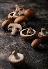 Raw champignon mushrooms on black background © Yulia Furman