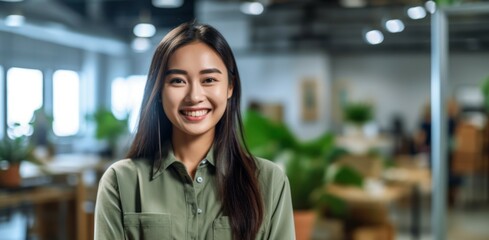 Portrait of happy asian woman smiling standing in modern office space. 