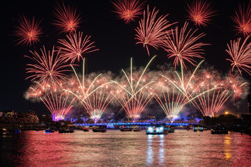 Beautiful fireworks Phra Phuttha Yodfa Bridge or Memorial Bridge light up with fireworks event show. ‘Vijit Chao Phraya’ lighting extravaganza with firework at Memorial Bridge, Bangkok, Thailand