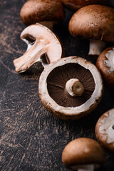 Raw champignon mushrooms on black background