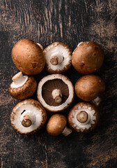 Raw champignon mushrooms on black background