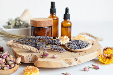 Botanical blends, herbs, essencial oils for naturopathy. Natural remedy, herbal medicine, blends for bath and tea on wooden table background - obrazy, fototapety, plakaty
