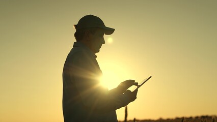 silhouette farmer works tablet. Embracing golden hour modern farm, where innovation meets...