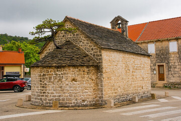 The Brac Bonsai Tree, a  Dalmatian black pine growing out of the roof of the historic Church of Saints Michael, Peter and Paul in Nerezisca, Brac Island, Croatia