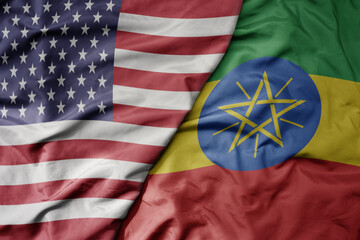 big waving colorful flag of united states of america and national flag of ethiopia .