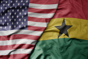 big waving colorful flag of united states of america and national flag of ghana .