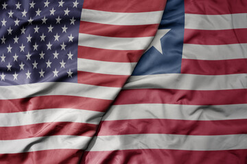 big waving colorful flag of united states of america and national flag of liberia .