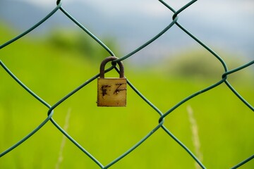 Rusty Padlock on the gate in the meadow fence. Slovakia