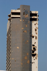 Fototapeta premium War damaged exterior of the former Holiday Inn, Beirut, Lebanon. Civil war in the Middle East 