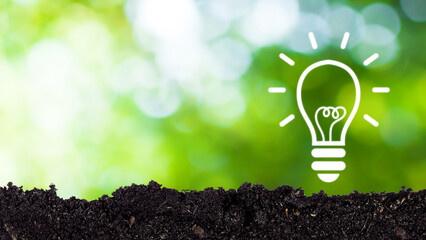 Light bulb symbol virtual concept energy an idea put on the soil on green nature background....